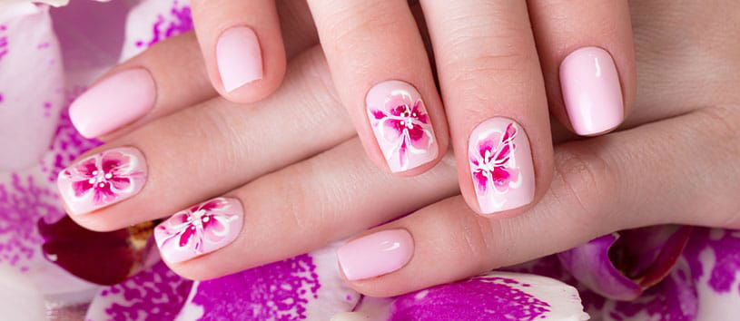 Closeup of a pink floral manicure.
