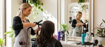 Cosmetologist in a salon working on a client's hair